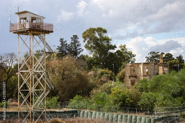Fototapeta Old UN tower and a destroyed building in the UN buffer zone Nicosia, Cyprus