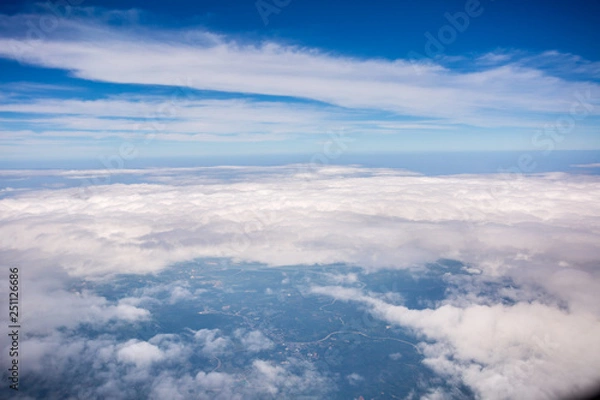Fototapeta White cloud and blue sky at atmosphere Level, photo taken through the plane window