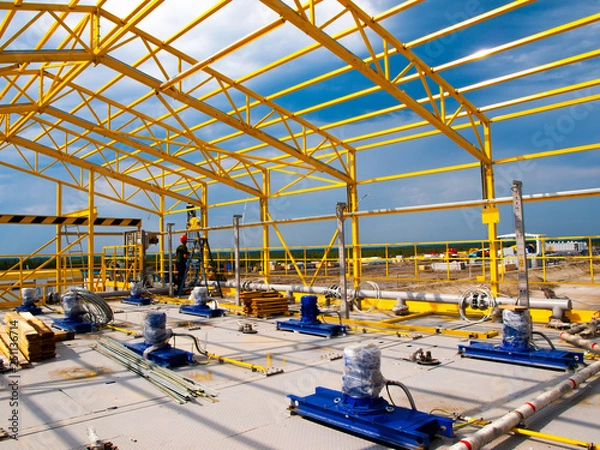 Fototapeta platform containers and yellow frame the platform of tanks and mixers for the yellow frame of the rig hangar
