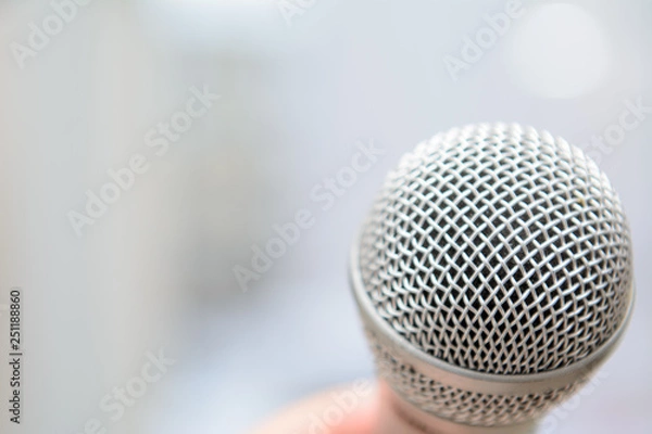 Obraz studio microphone on a blurred background in male hand