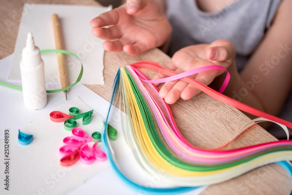 Obraz Quilling technique. Making decorations or greeting card. Paper strips, flower, scissors. Handmade crafts on holiday: Birthday, Mother's or Father's Day, March 8, Wedding. Children's DIY concept.