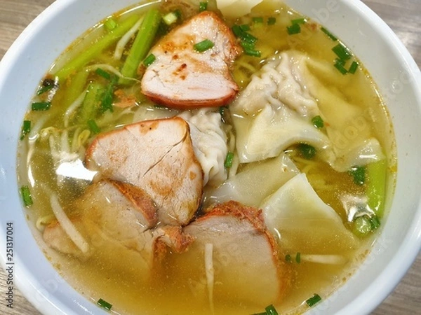 Obraz Top view of shrimp wonton with bbq pork and clear soup topped with sliced scallion in white bowl, Kiao Nam is Thai traditional