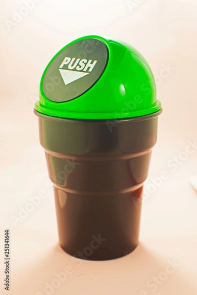 Fototapeta Trash recycling container ecology concept. Recycle bin on table in office in pink background. Separation of garbage in office buildings.