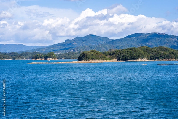 Fototapeta Many small islands over the blue ocean in sunny day, famous Kujukushima(99 islands) pearl sea resort islet in Sasebo Saikai National Park, Nagasaki, Kyushu, Japan.