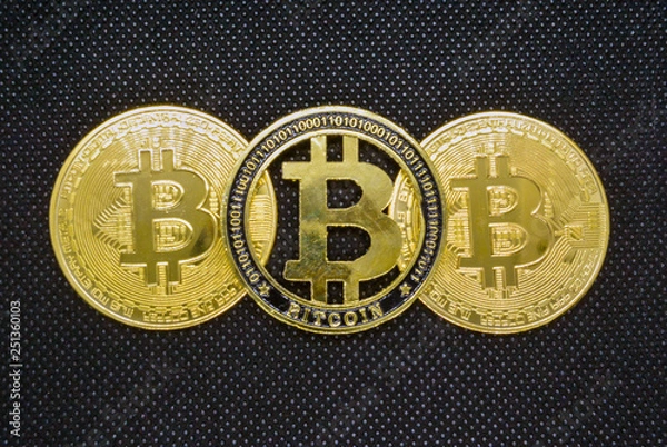 Obraz  bitcoin black perforated background.