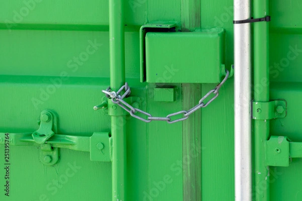 Fototapeta Green storage container locked with chain