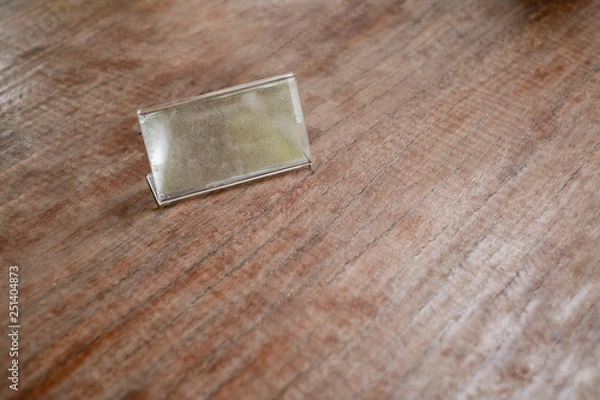 Fototapeta Mock up Label the blank menu frameon wooden table cafeteria blurred background can inserting the text.