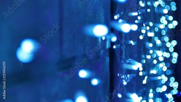 Obraz garlands Fires burn and flicker shimmer on the wall in soft focus bokeh Christmas or New Year background.