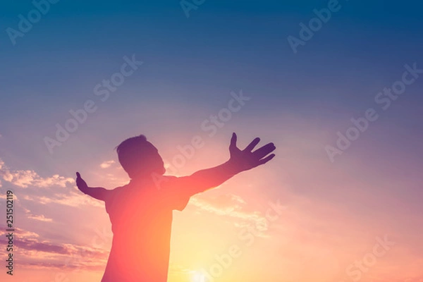 Fototapeta  Copy space of happy man raise hands on sunset sky with sun light abstract background.