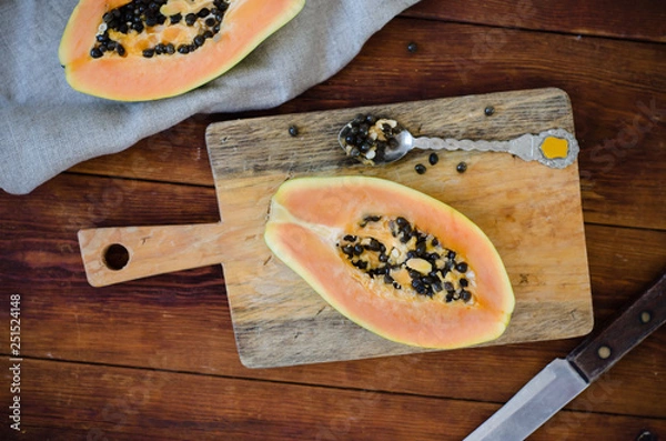 Obraz Papaya on a cutting board on a wooden table
