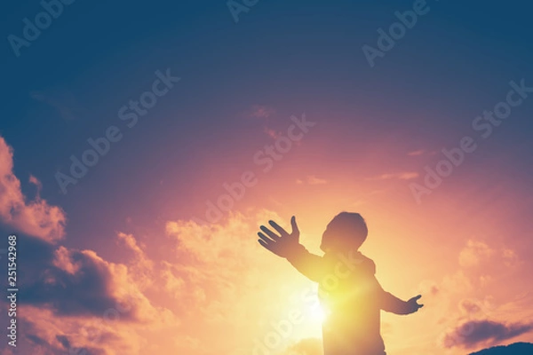 Fototapeta Copy space of man rise hand up on top of mountain and sunset sky abstract background.