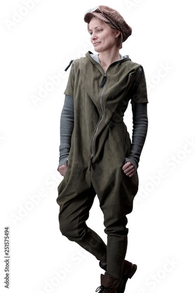 Fototapeta Young woman in a green jumpsuit in a cap and glasses posing in the studio isolated on a white background.