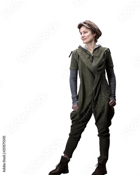 Fototapeta Young woman in a green jumpsuit in a cap and glasses posing in the studio isolated on a white background.
