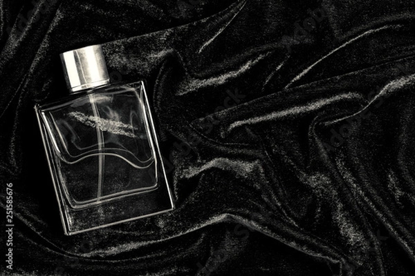 Obraz Male perfume bottle with copy space on black fabric background