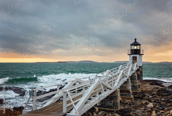Fototapeta Lighthouse with small wave breaking