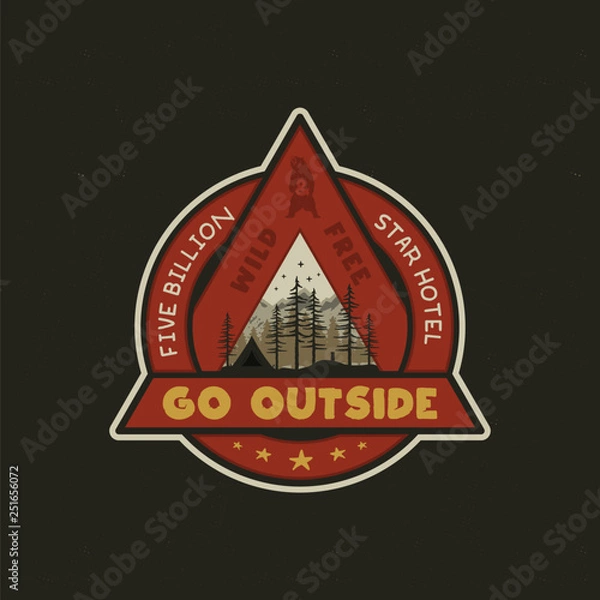 Obraz Hand drawn adventure logo with camp tent, mountains, pine trees forest and quote - Go outside, wild and free, five billion star hotel. Old style outdoors adventure emblem in retro style. Stock vector