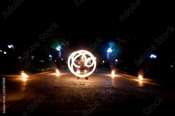 Obraz Amazing fire show dance. Fire dancer playing with flame