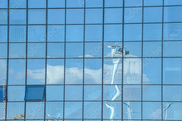 Fototapeta Sky and cloud reflection in windows of modern skyscrapers