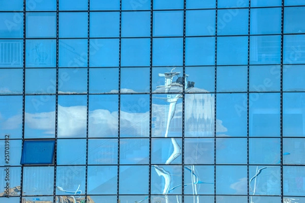Fototapeta Sky and cloud reflection in windows of modern skyscrapers