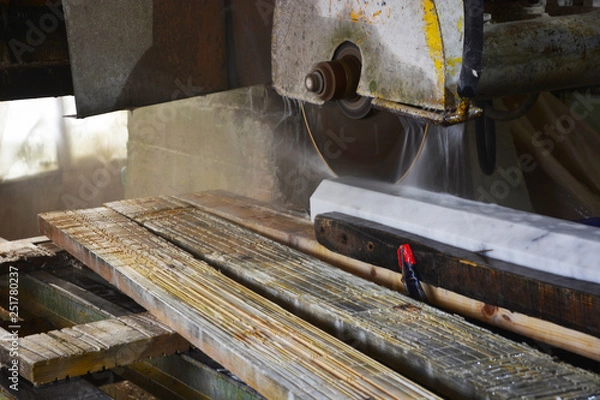Obraz worker cutting metal with saw