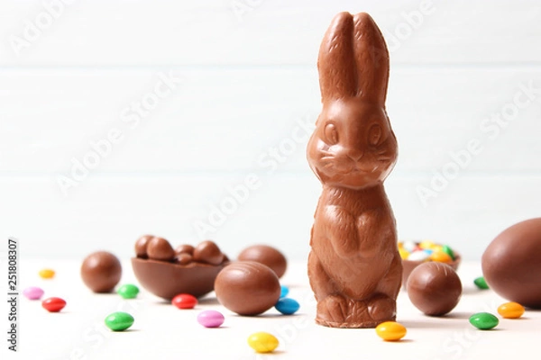 Fototapeta  Easter composition with chocolate eggs and chocolate rabbit on wooden background, place for text 
