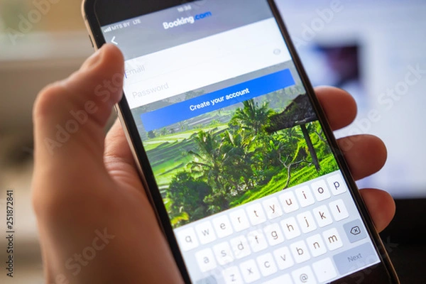 Fototapeta Booking application on mobile smartphone screen. Username and password for booking.com