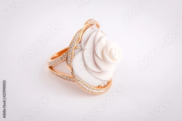 Fototapeta Gold women's ring with white stone in the shape of a rose with a white diamonds isolated on a white background.