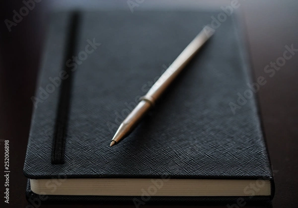 Obraz a pen on a notebook