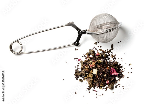 Fototapeta Tea strainer and a slide of herbal tea on a white isolated background. Close-up. Side view.