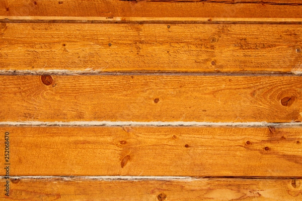Fototapeta The wall of wooden beam. Close-up. Horizontal view. Background. Texture.