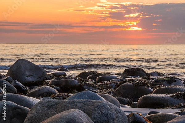 Fototapeta sunset on Unstad beach surrounded by mountains in Lofoten in Norway
