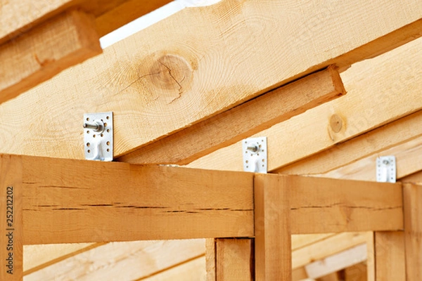 Fototapeta Construction details - framing installing the roof truss system
