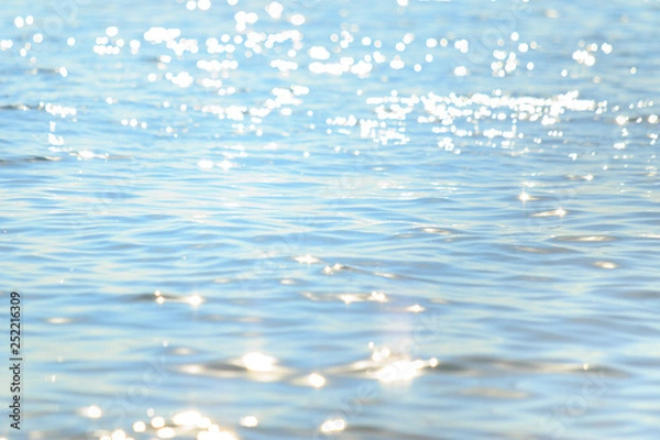 Obraz Sun light reflecting or sparkling glitter on water of sea or ocean with beautiful sky blue light tone.