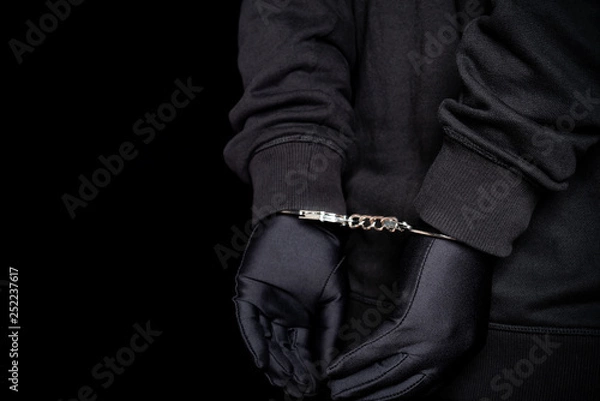 Fototapeta arrested man in handcuffs with hands on back