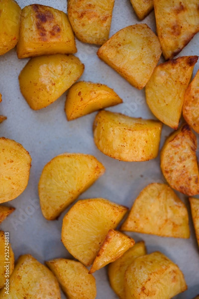 Fototapeta Close up of baking tray with Patatas Bravas, a traditional Spanish tapas dish, potato cubes or wedges roasted, baked or deep fried until tender and cripsy on the outside