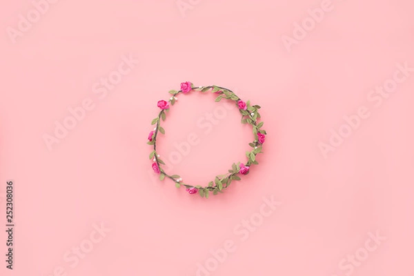 Fototapeta Wreath of flowers and leaves on a pink background. Flat lay, copy space, top view. Flowers composition.