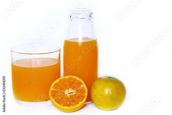 Fototapeta The Orange juice bottle with orange juice glass and orange, half fresh oranges isolated on white background