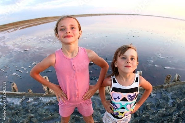 Obraz Summer portrait of a girl close-up, on a salt lake in the sunset, girl with contented and playful faces, posing for a photo