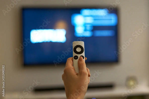 Obraz Holding hand on remote control