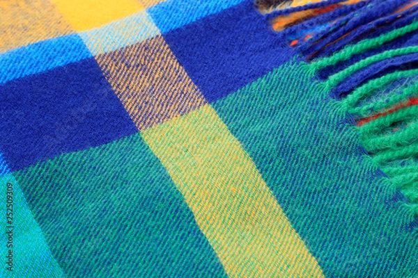 Fototapeta Texture of a bright multicolor scarf with fringe