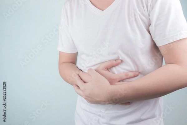Fototapeta Asian Young men are suffering from stomach ulcers. gastritis Caused by the infection of H. pylori bacteria  healthcare and health problem concept