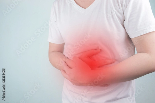 Fototapeta Asian Young men are suffering from stomach ulcers. gastritis Caused by the infection of H. pylori bacteria  healthcare and health problem concept