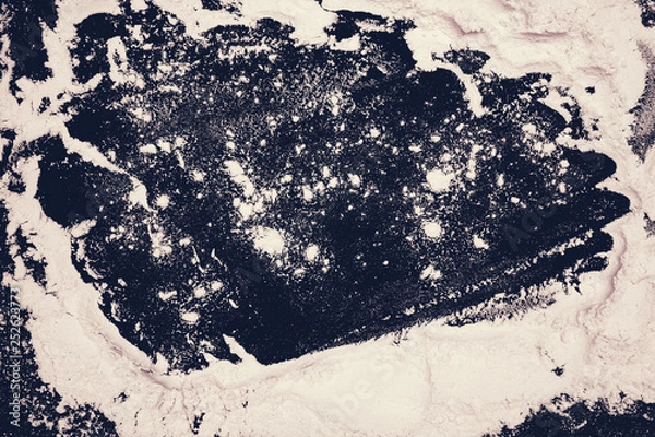 Fototapeta cooking baking. patterns of flour on a black background. rolling pin, flour. cooking dough