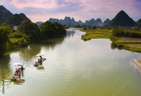 Obraz Bamboo Rafts drift down the Yulong River in Yangshuo, China