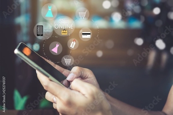 Fototapeta Women hand using smartphone do online selling for people shopping online with chat box, cart, dollar icons pop up. Social media maketing concept.