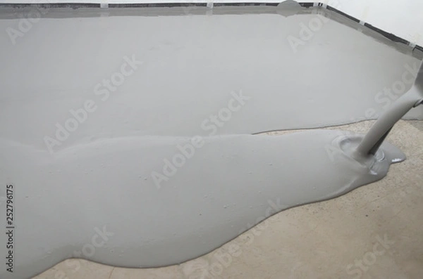 Fototapeta Self-leveling epoxy. Leveling with a mixture of cement floors.