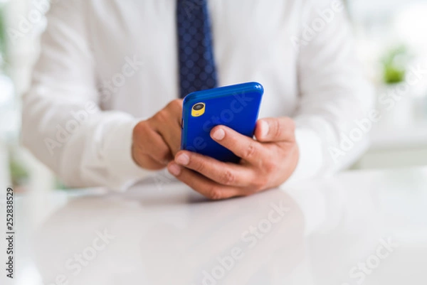 Fototapeta Close up of business man hands using smarpthone