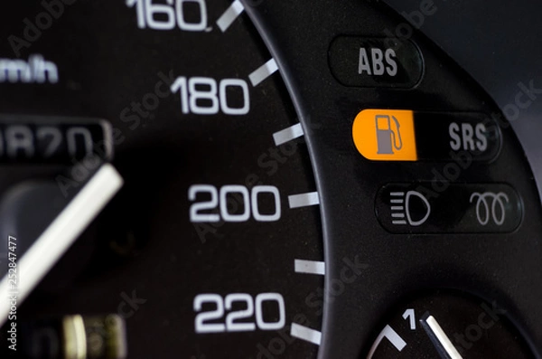 Fototapeta Close up empty Petrol, gasoline gauge dash board in car with digital warning sign of run out of fuel turn on on black background. Low level of fuel show on speedometer dashboard.