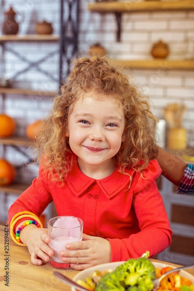 Obraz Positive delighted little female posing on camera