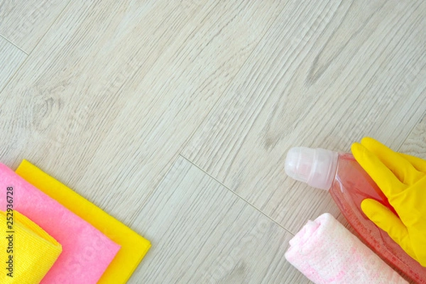 Fototapeta Flat lay composition with cleaning supplies on light wooden background. Service concept. Top view. Close up.